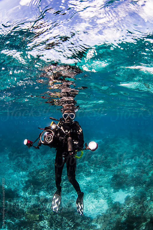 underwater photographer under surface with reflection