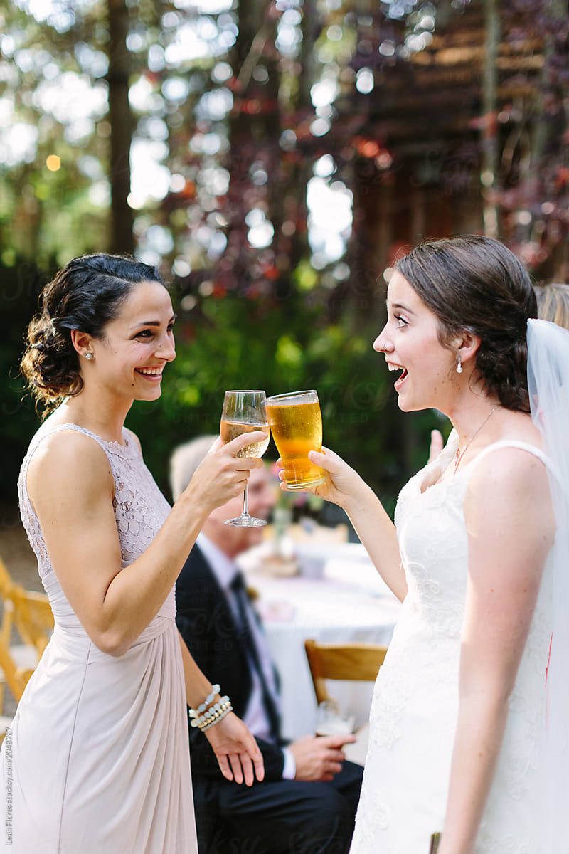 Bride and Bridesmaid Drinking At Reception