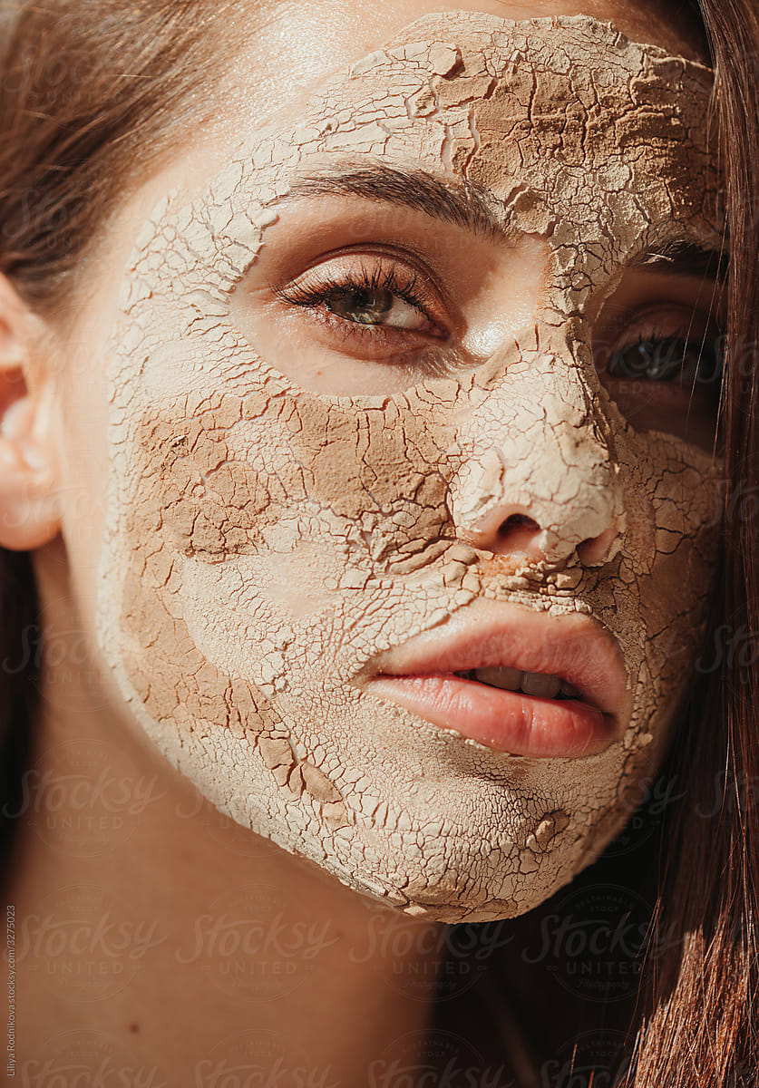 Beauty woman with clay mask on face