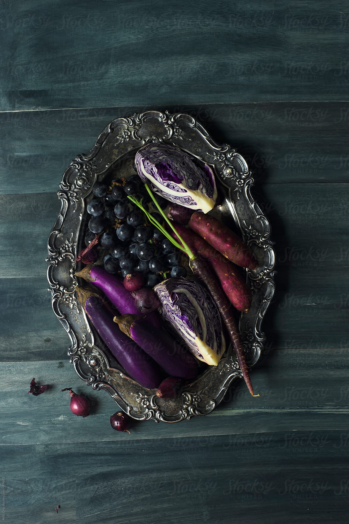 Purple fruits and vegetables on rustic metal tray