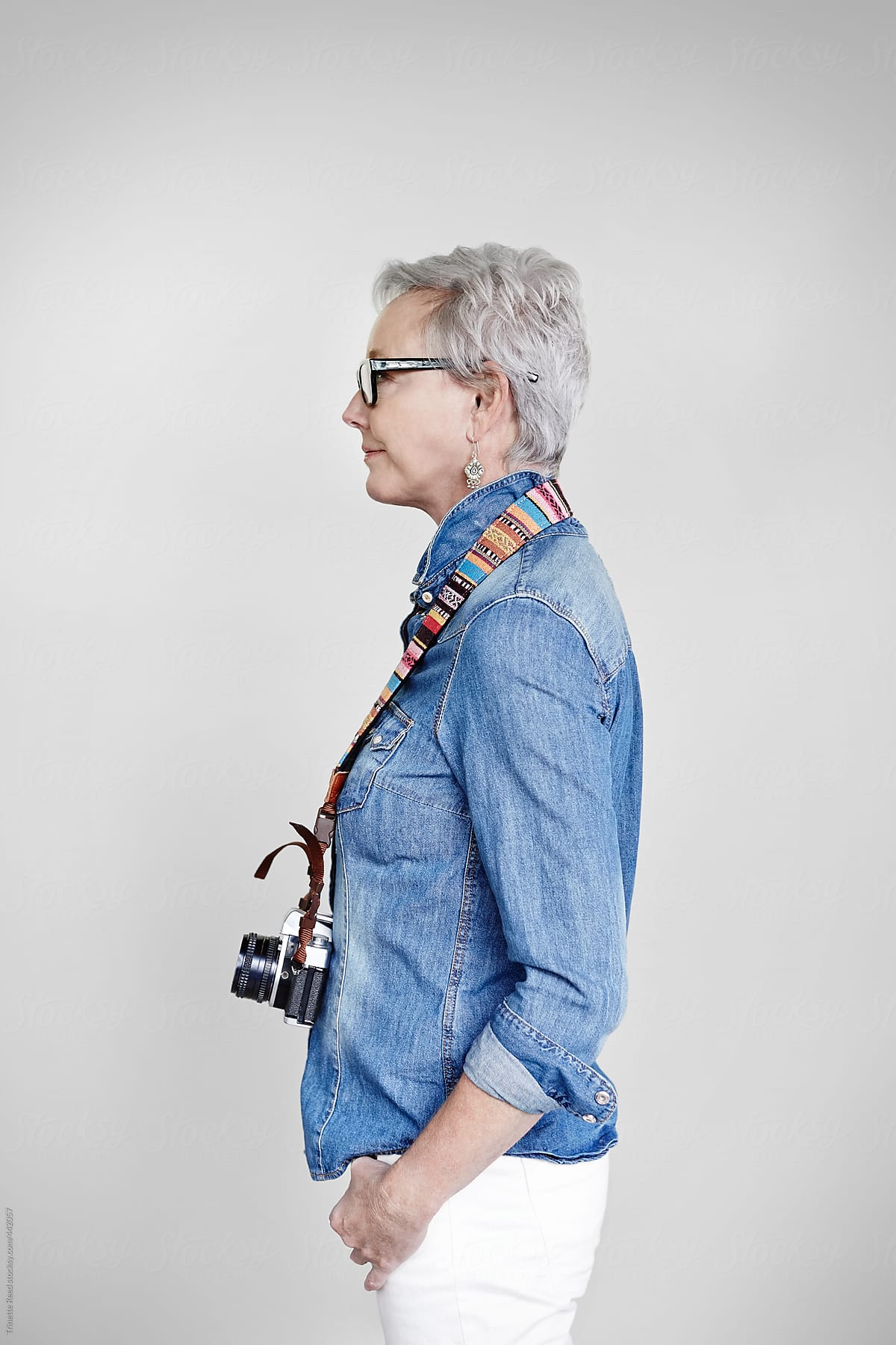 Portrait of stylish mature woman with vintage film camera
