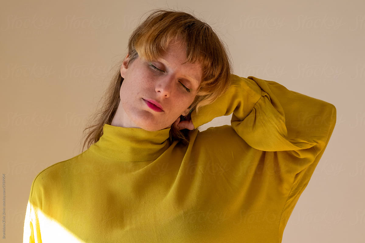 Portrait of a female model in a bright yellow blouse