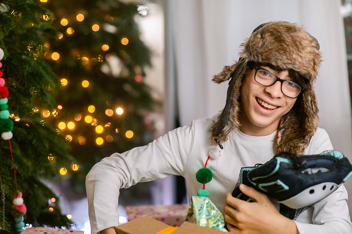 Portrait of happy teenager with gifts at Christmas