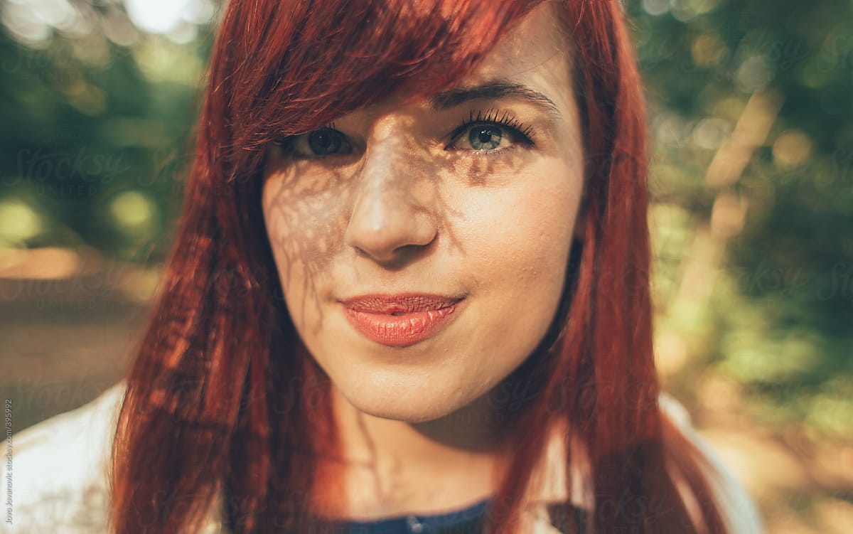 Portrait Of A Young Redhead Woman With An Interesting Shadow Pattern On