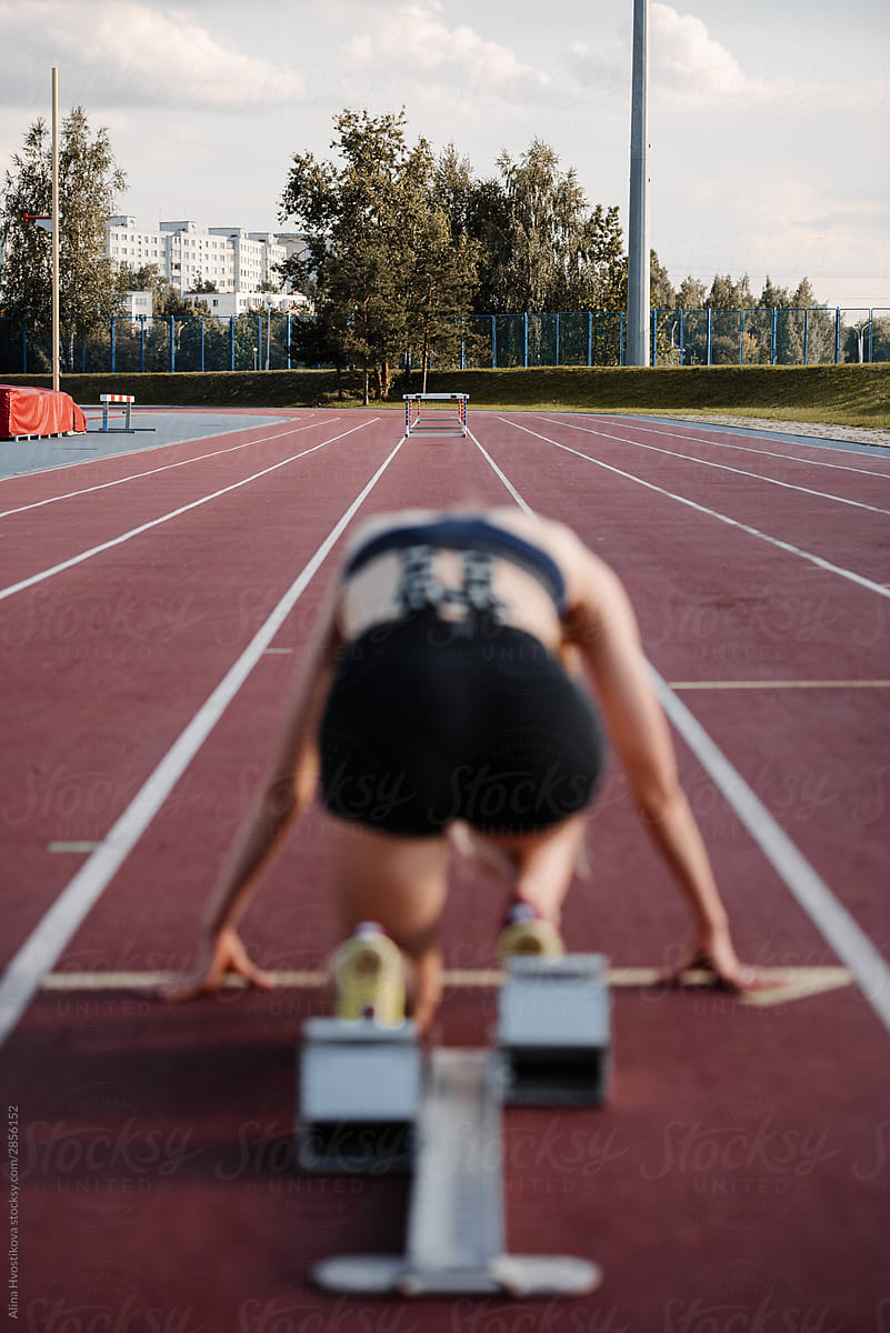 Female athlete at starting block on track