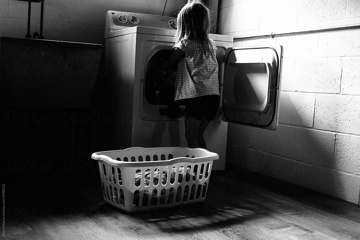 little girl does laundry
