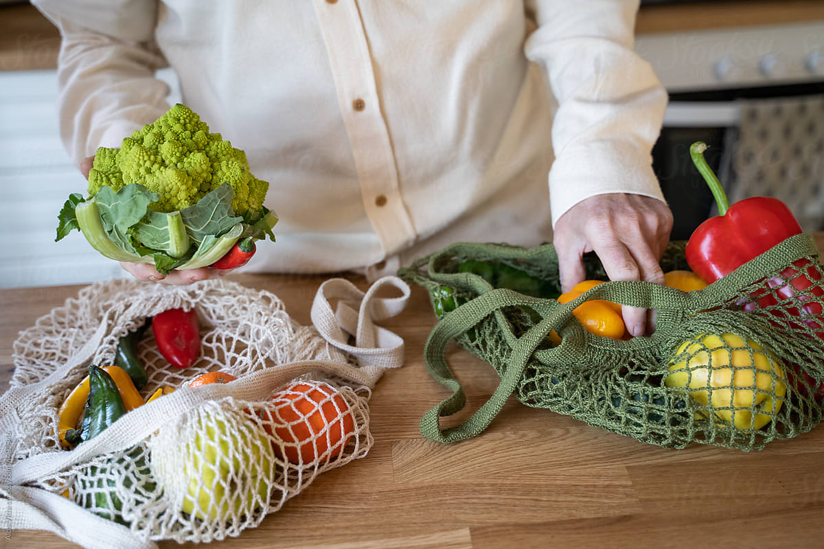 Man unpacking grocery shopping bag with vegetables