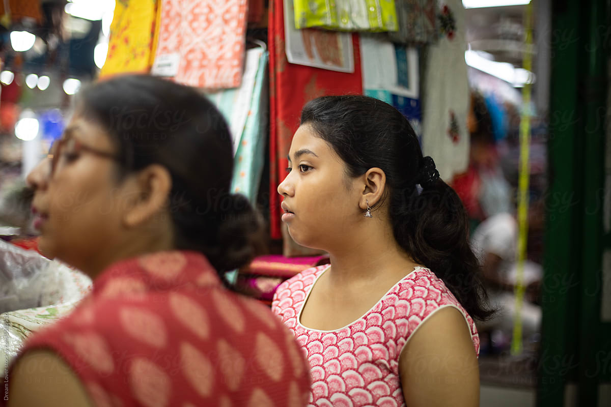 Mother and daughter buying dress material in a shop