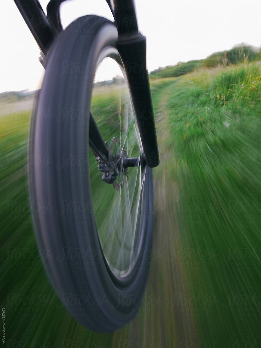bike wheel motion blurred along a path