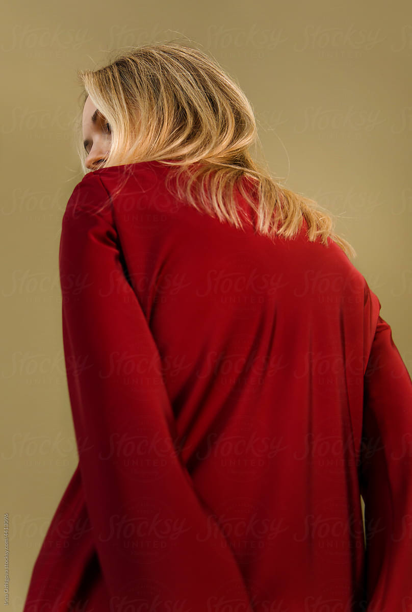 Woman in red dress and blond hair in studio