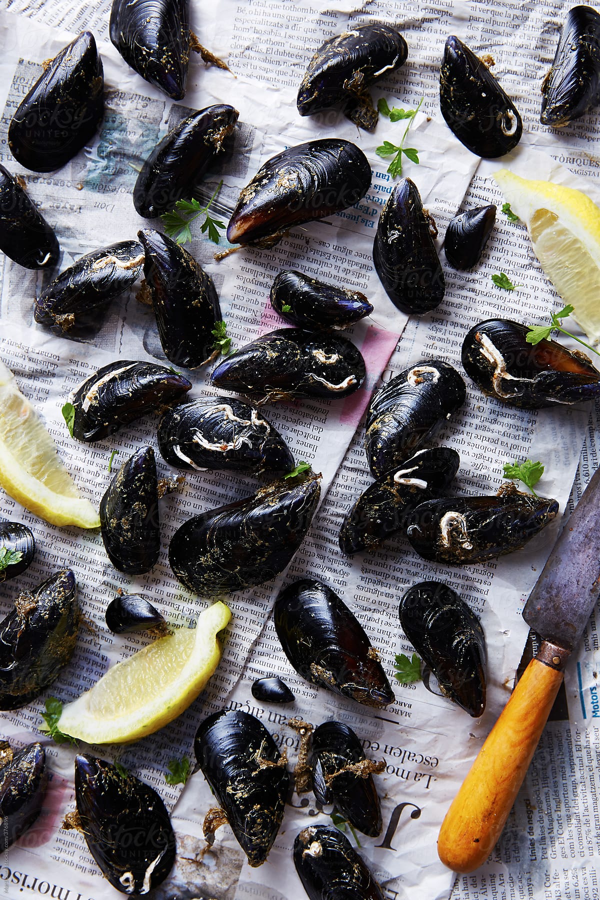 Cleaning mussels on newspaper background