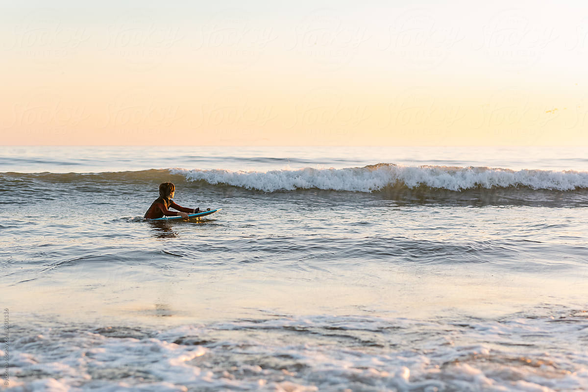 Teen boy enjoying the cold ocean beach in California