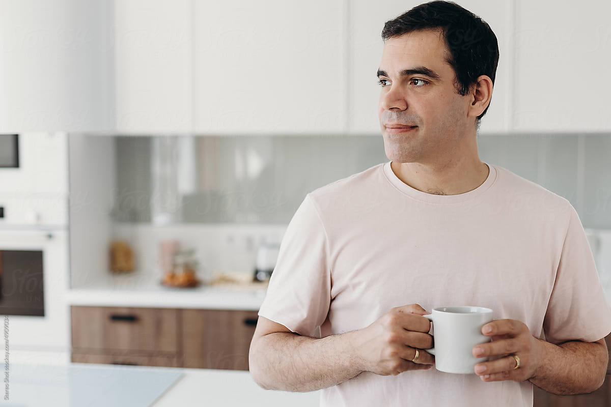 Calm Hispanic man with coffee at home