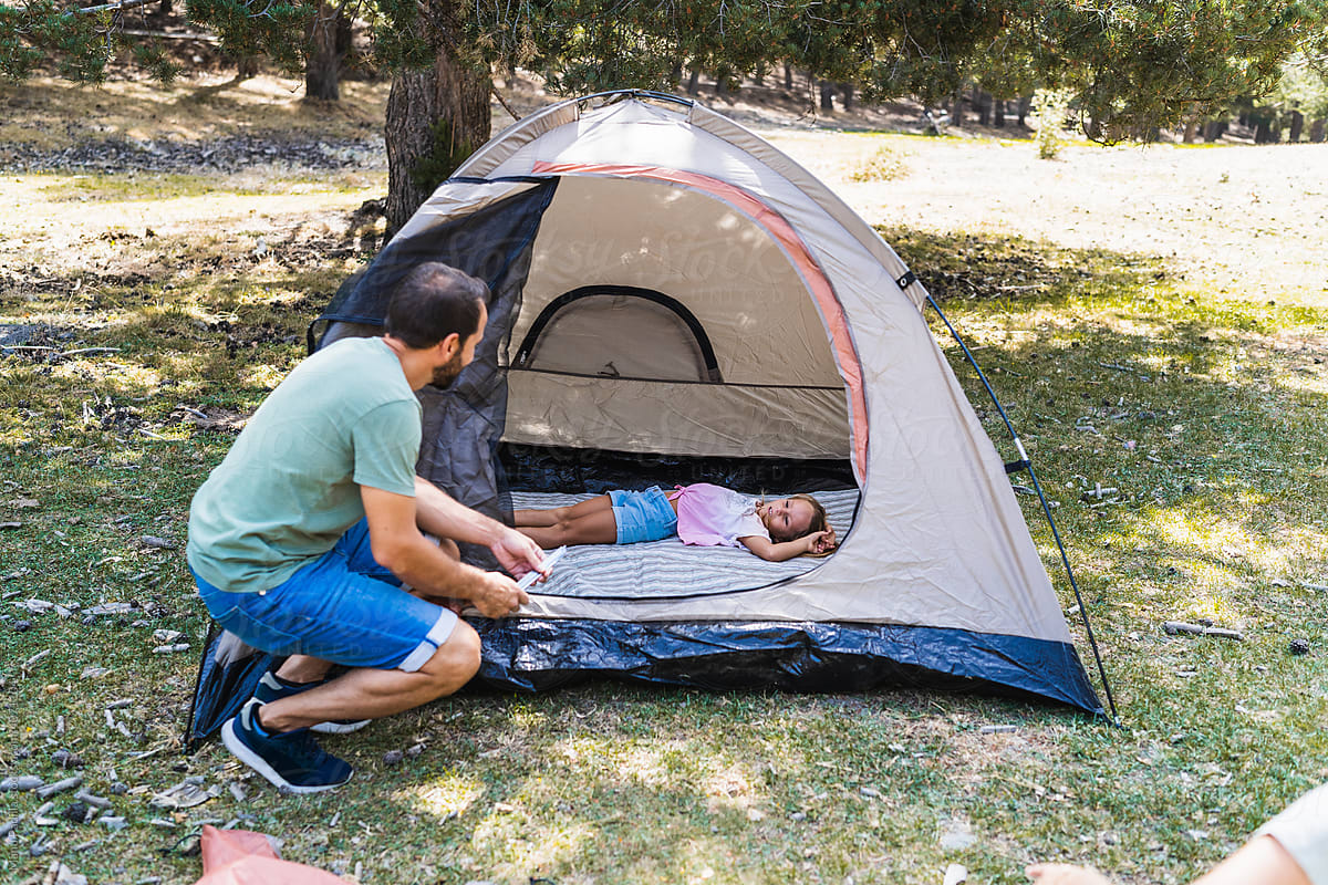 Father speaking with daughter in tent