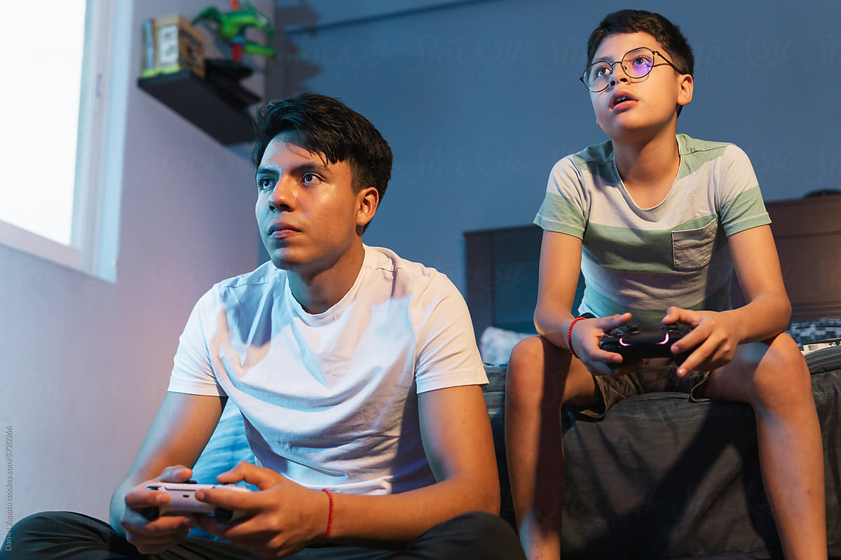 Teenagers at home playing video games.
