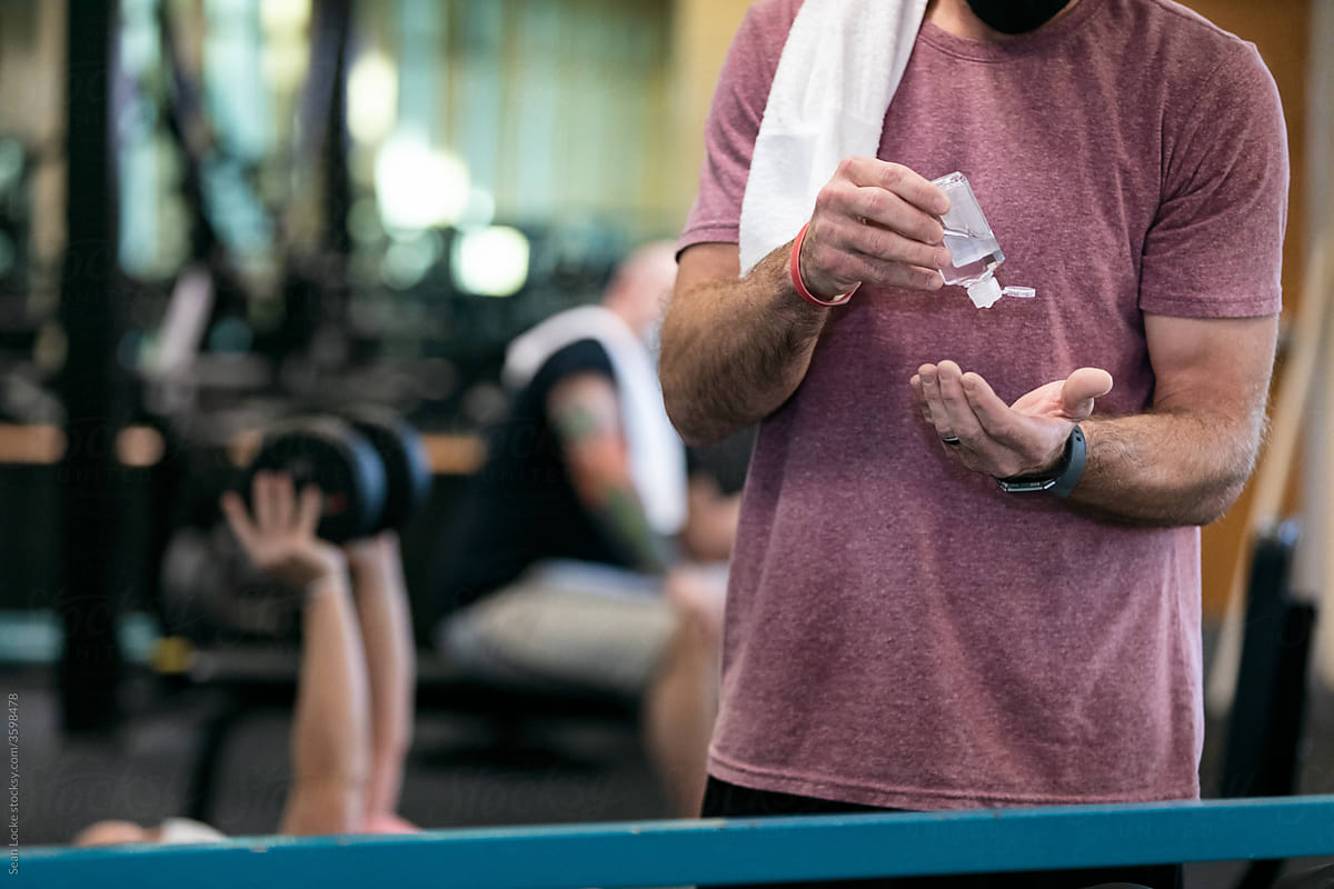 Gym: Man Uses Hand Sanitizer While Working Out