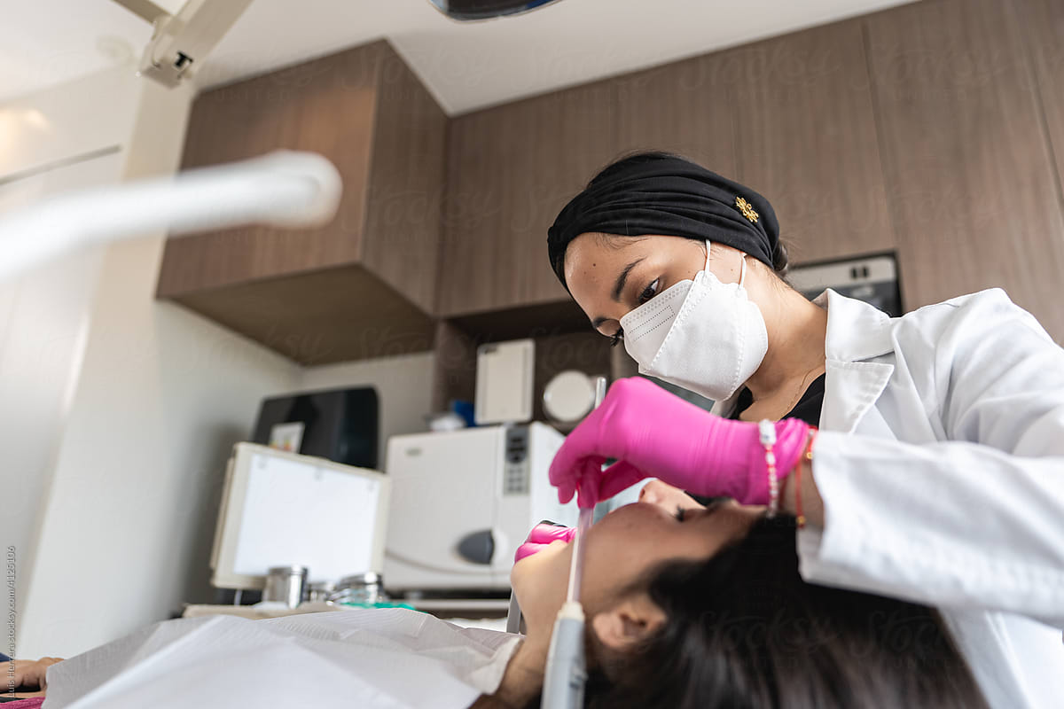 female dentist treating a patient