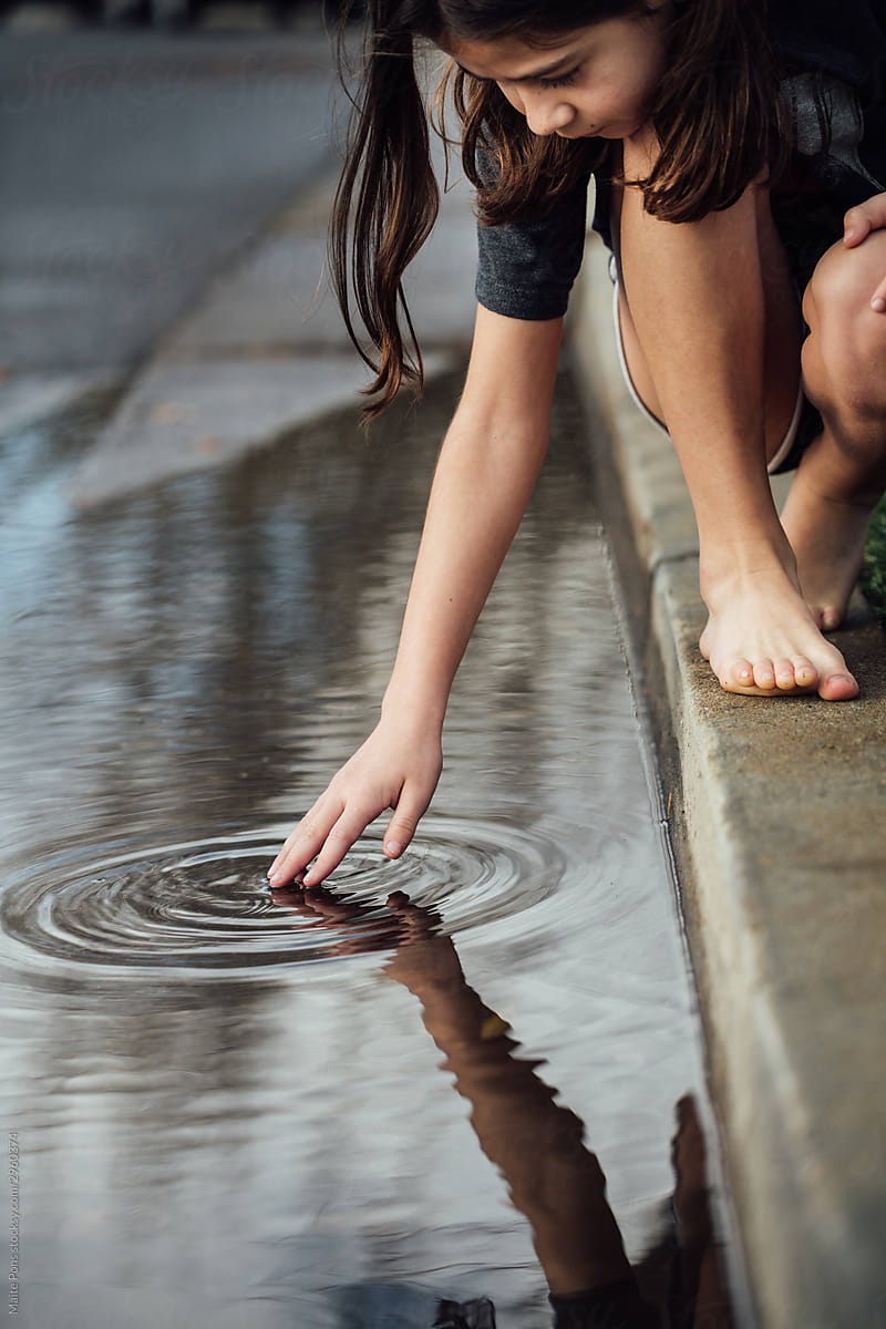 Girl Playing with Puddle