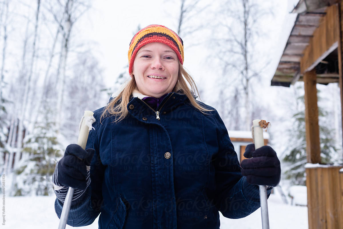 Happy woman with ski poles