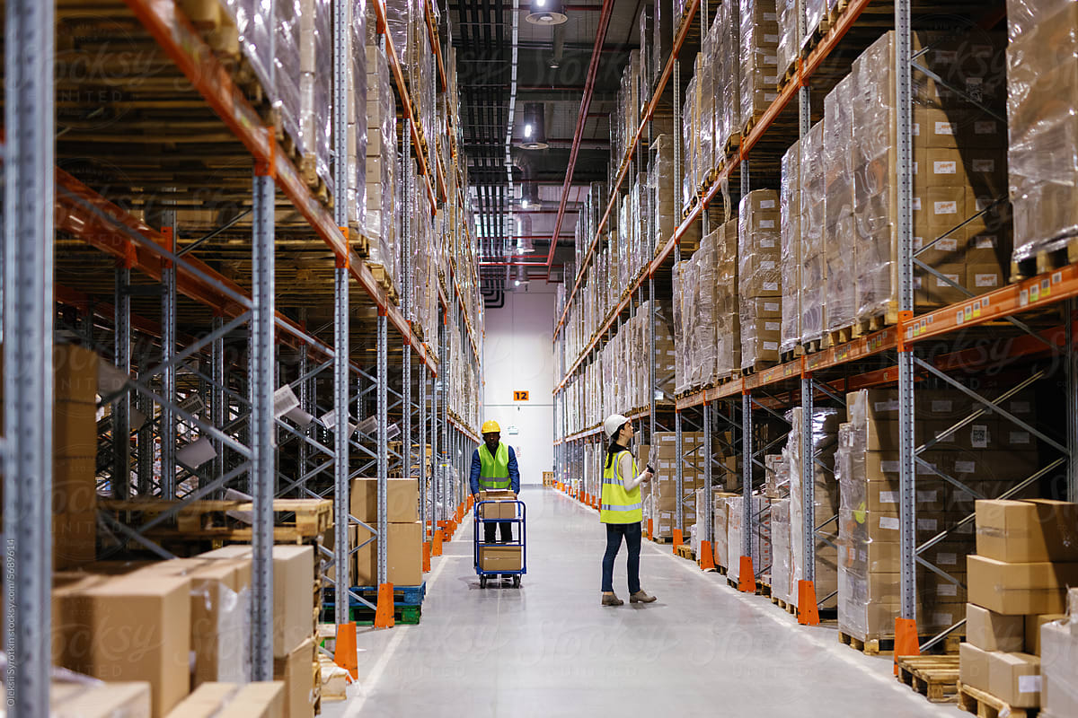 Uniformed workers scan carry merchandise storage room