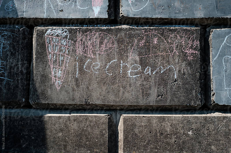\'Ice cream\' written in chalk on concrete block by child