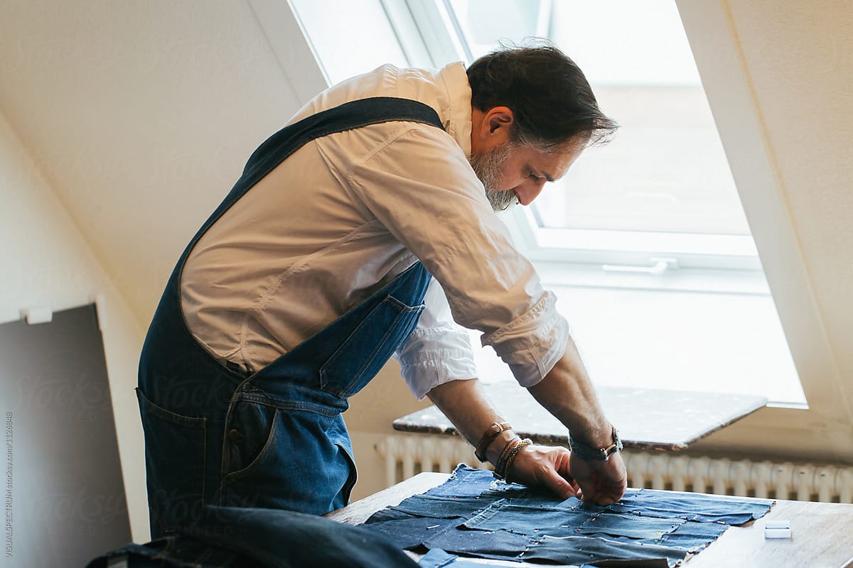 Indoor Portrait of Cool Senior Male Tailor Creating Patchwork Fabric