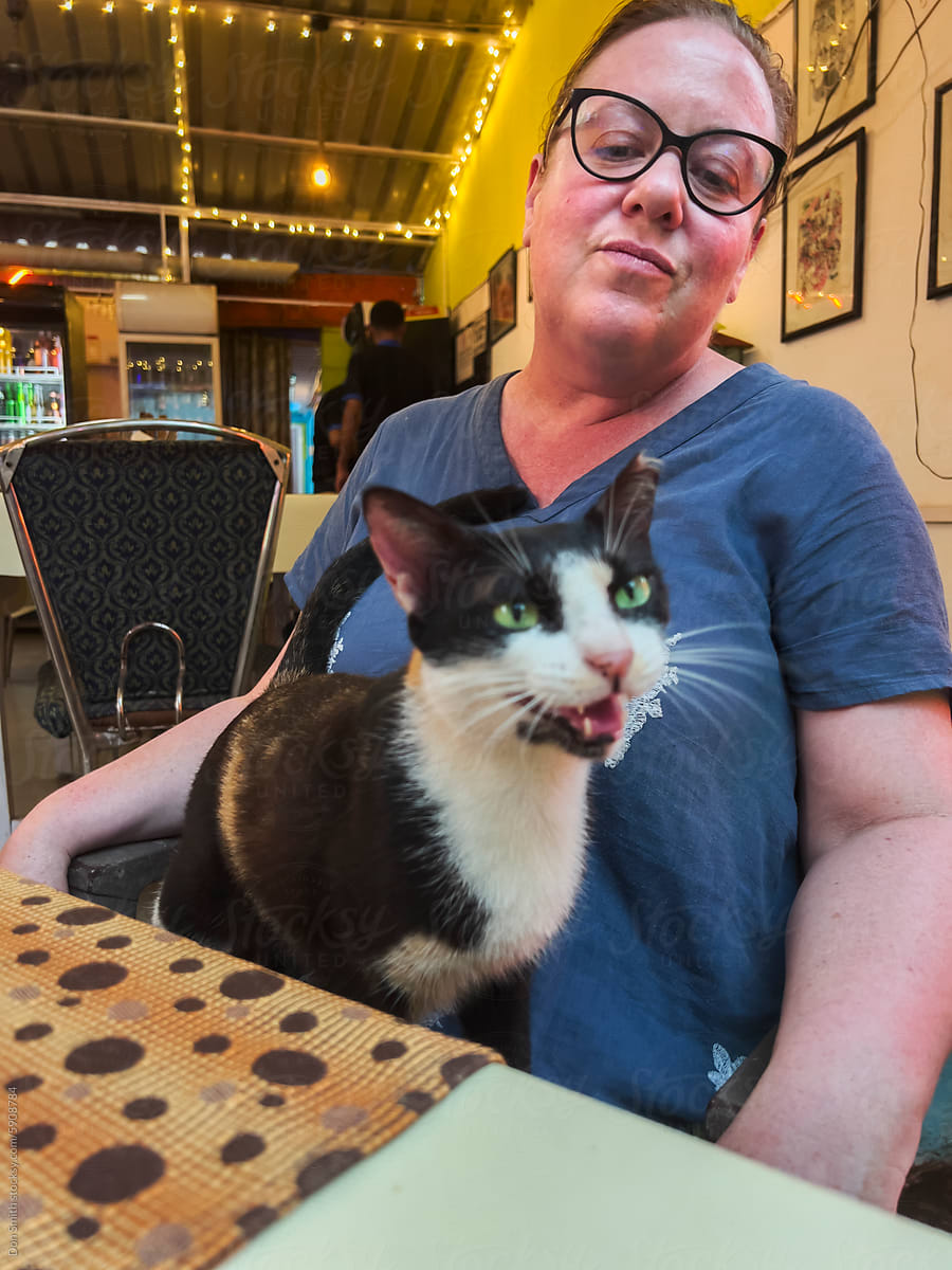 Cat on lap in restaurant