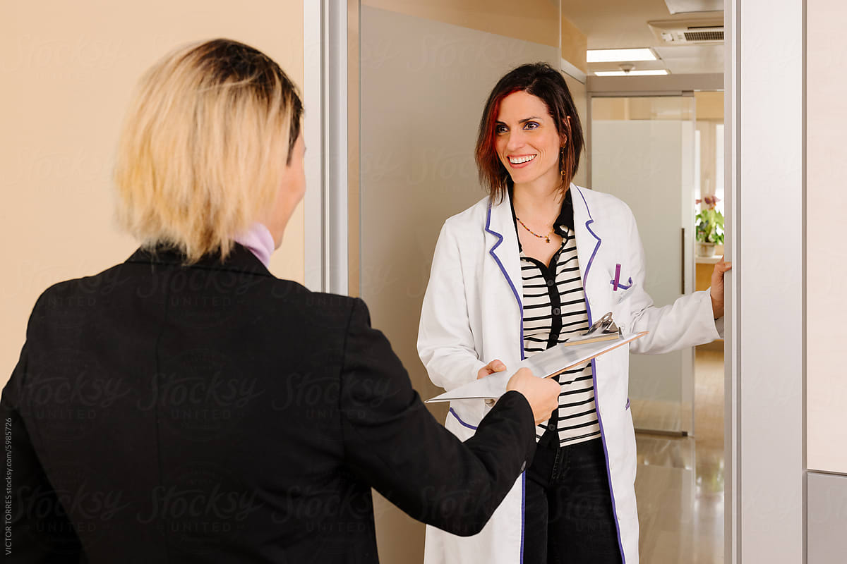 Smiling Doctor Welcoming Patient at Clinic