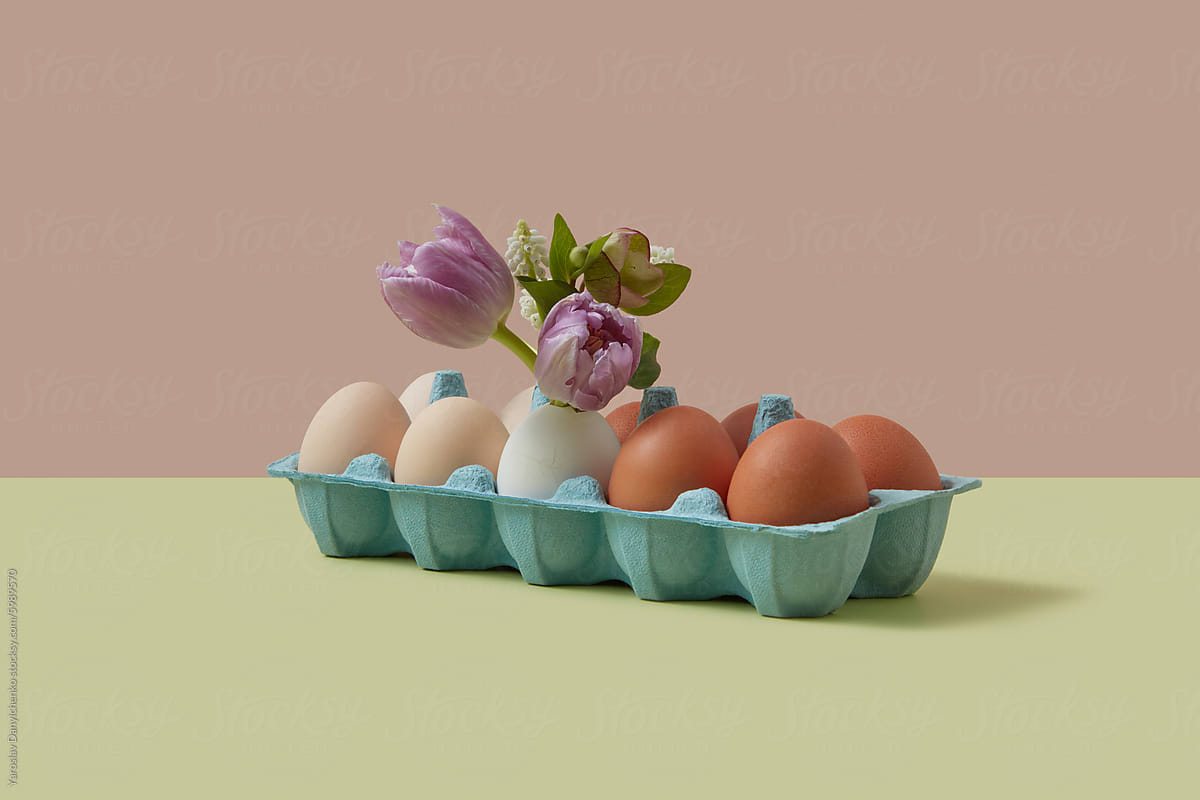 Dozen of chicken eggs in package decorated with flowers