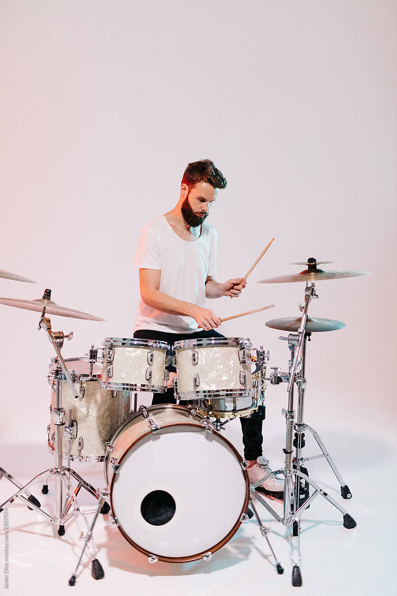 Man playing drums on white background