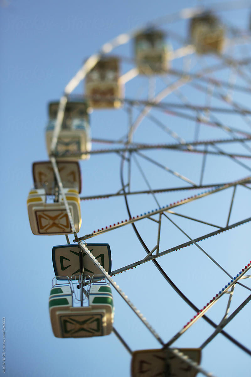 An Empty Ferris Wheel Against A Bright Blue Sky