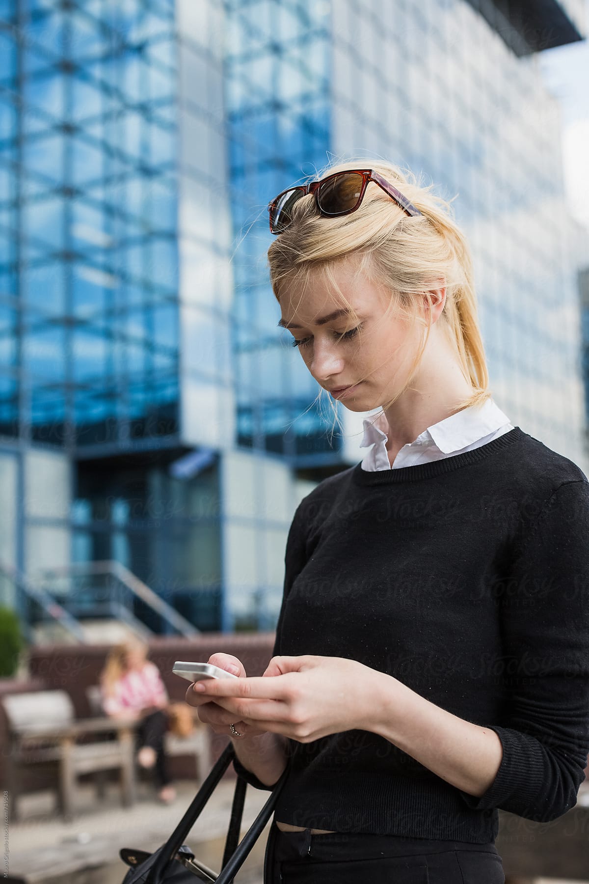 Business woman using a smartphone outdoor