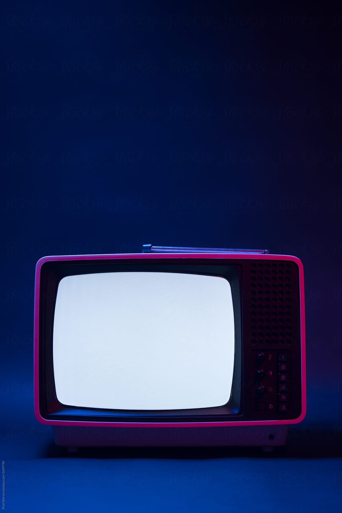 Old analog TV displaying noise under blue and red light