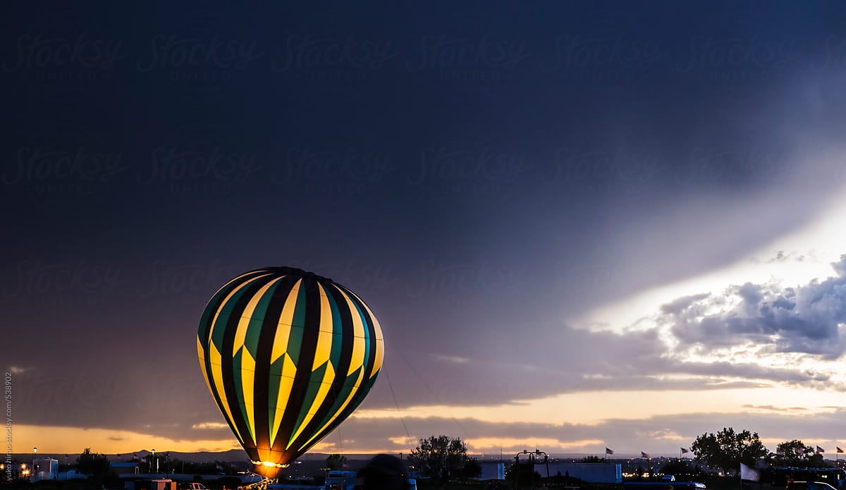 Hot air balloon glows in a stormy weather