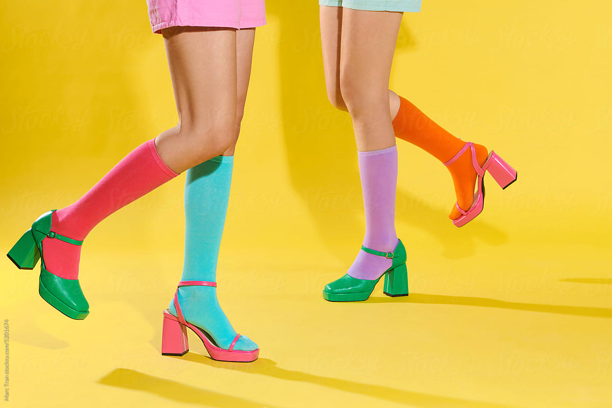 colorful socks on perfect woman legs with green- pink shoes