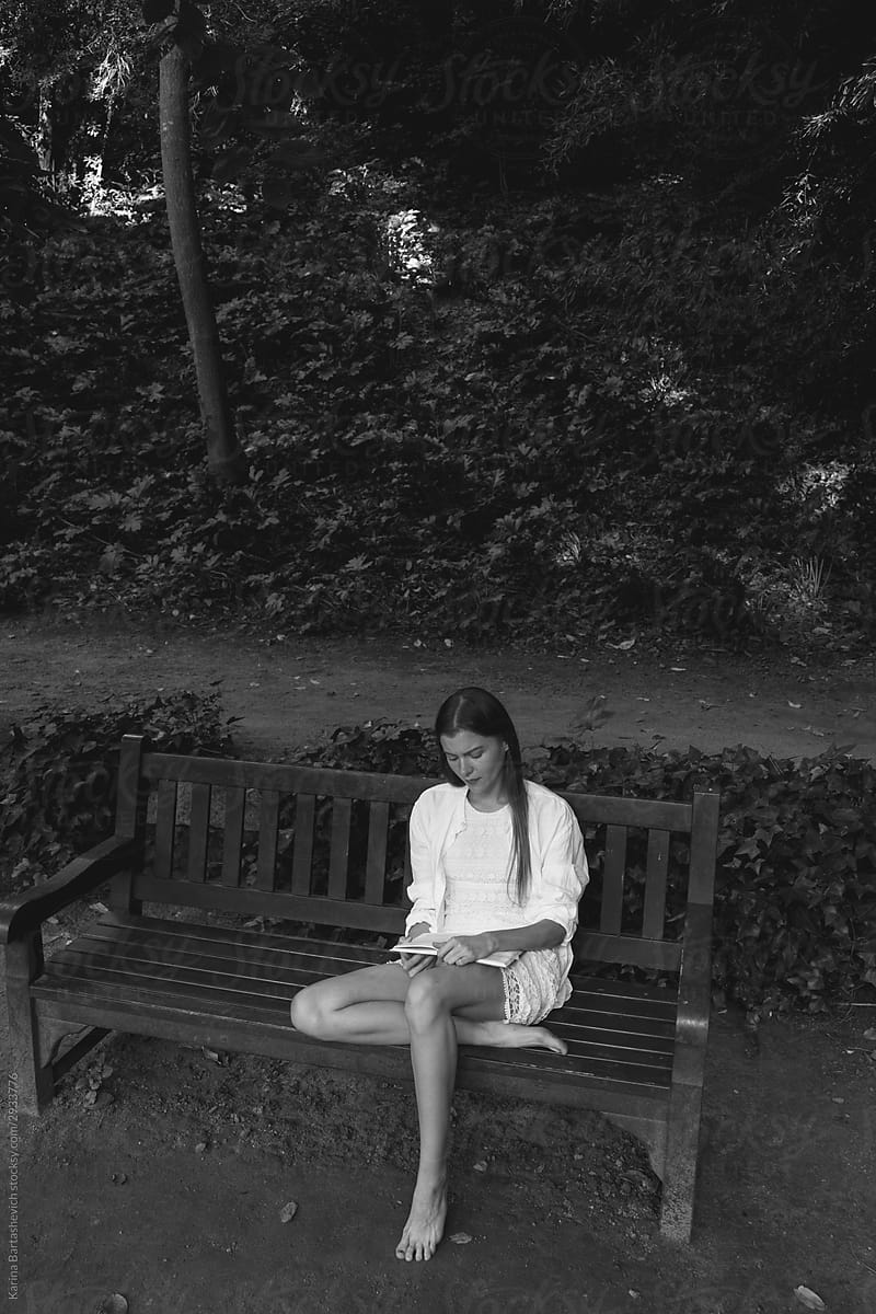 girl sitting on a bench in the park