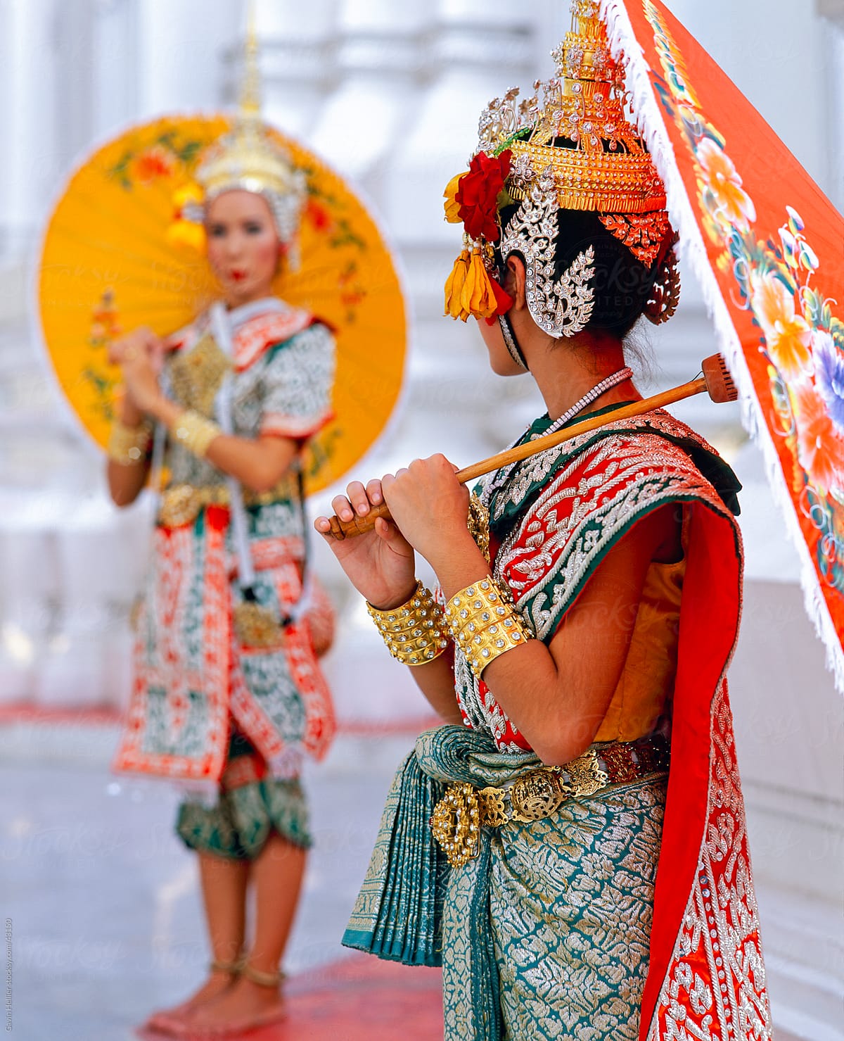 South East Asia, Thailand, Bangkok, two Thai dancers in traditional dance costume holding colourful umbrellas