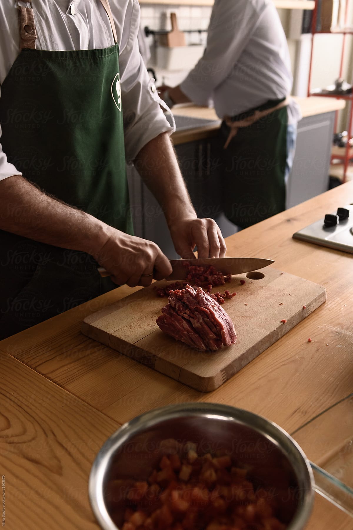 Cook slicing meat on board