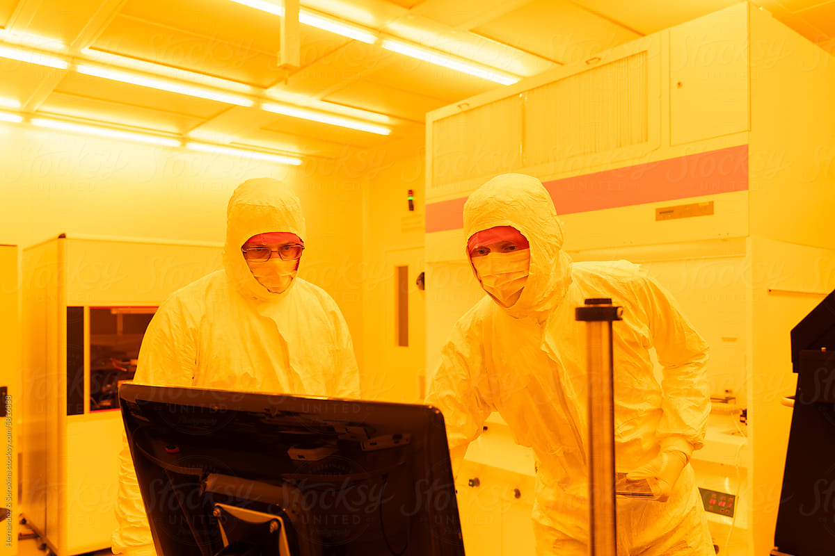 Researchers Working With Computer At Clean Room