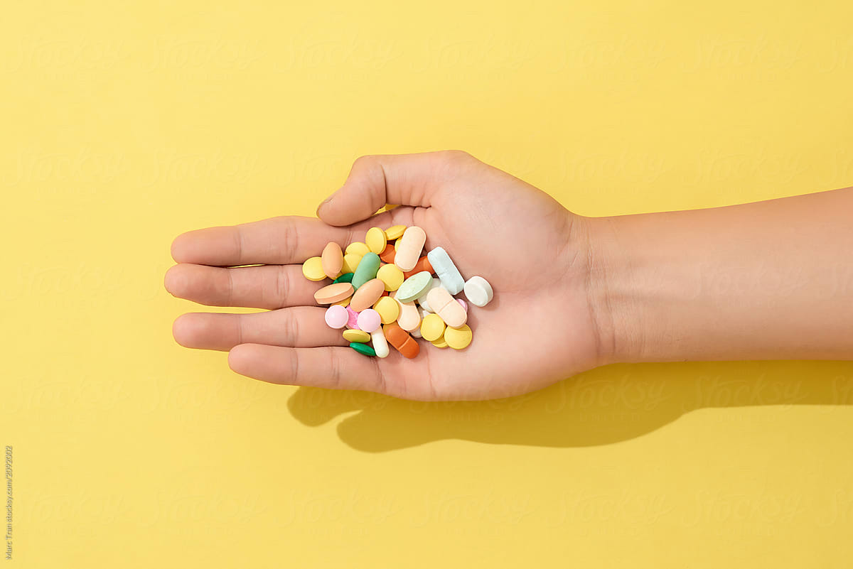 Multiple colors pills in hand