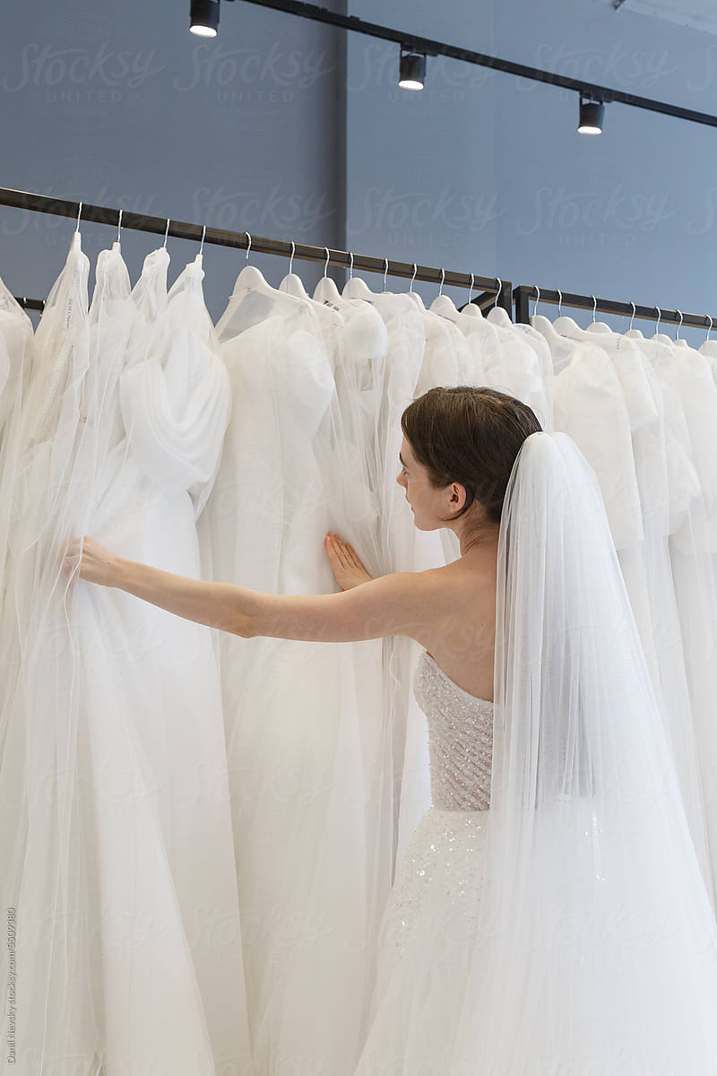 Bride checking new wedding dress at showroom