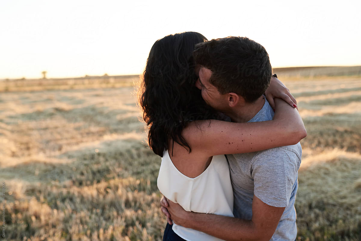 Happy Couple Hugging On Field By Stocksy Contributor Guille Faingold Stocksy 