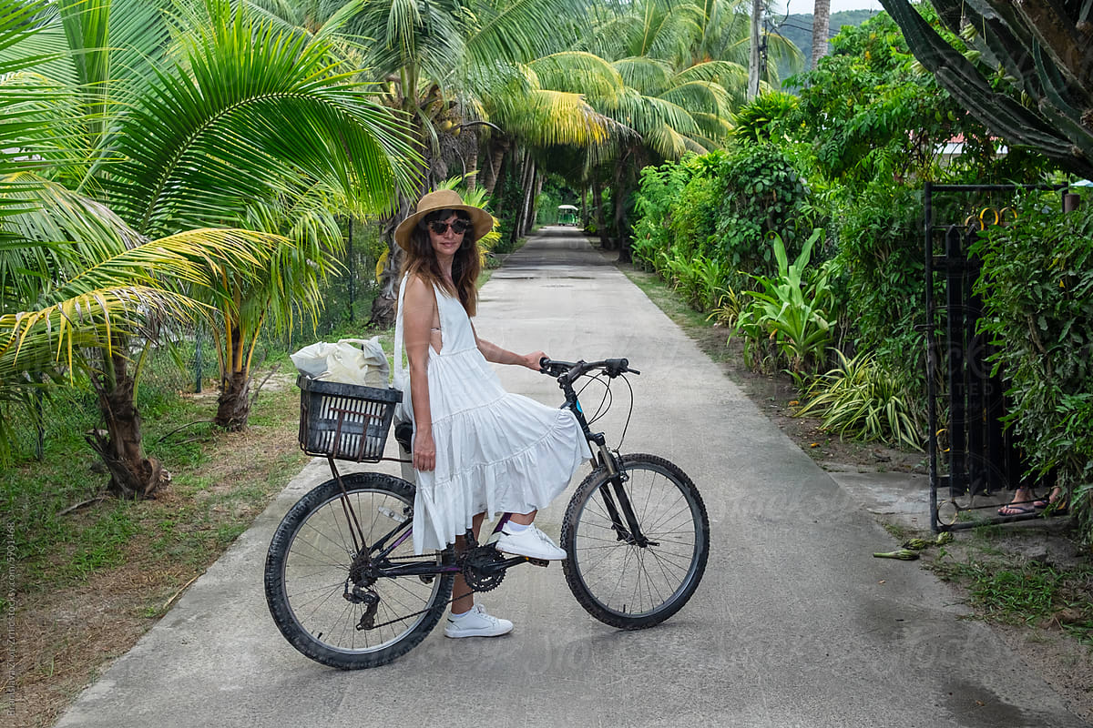 Female riding a bicycle on La Digue Island - Seychelles
