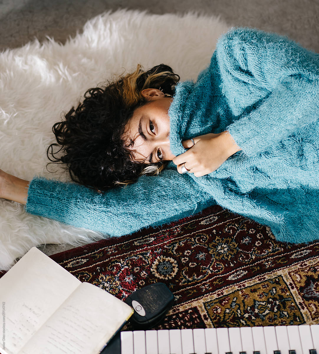 Melancholic Young Woman Lying On Floor And Dreaming At Home By