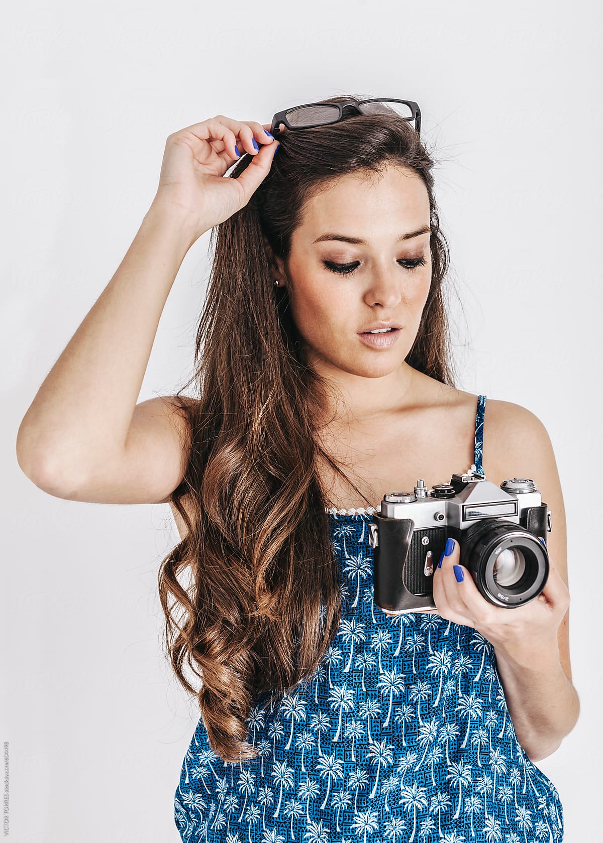 Young Woman Holding a Retro Camera
