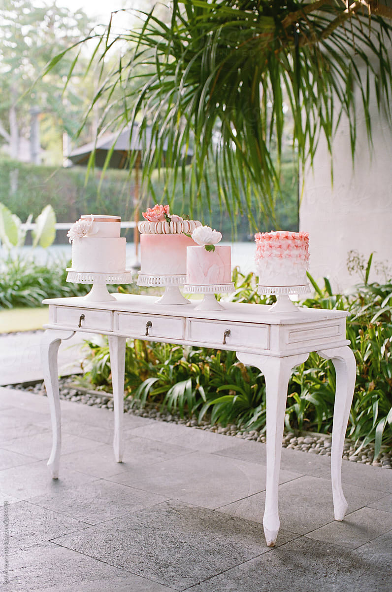 Four Pink and white decorated wedding cakes