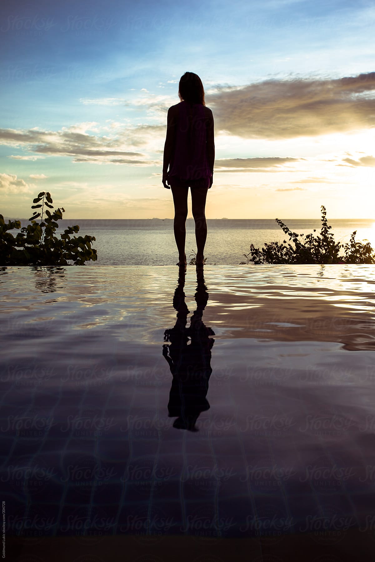 Woman Standing on the Edge of a Swimming Pool