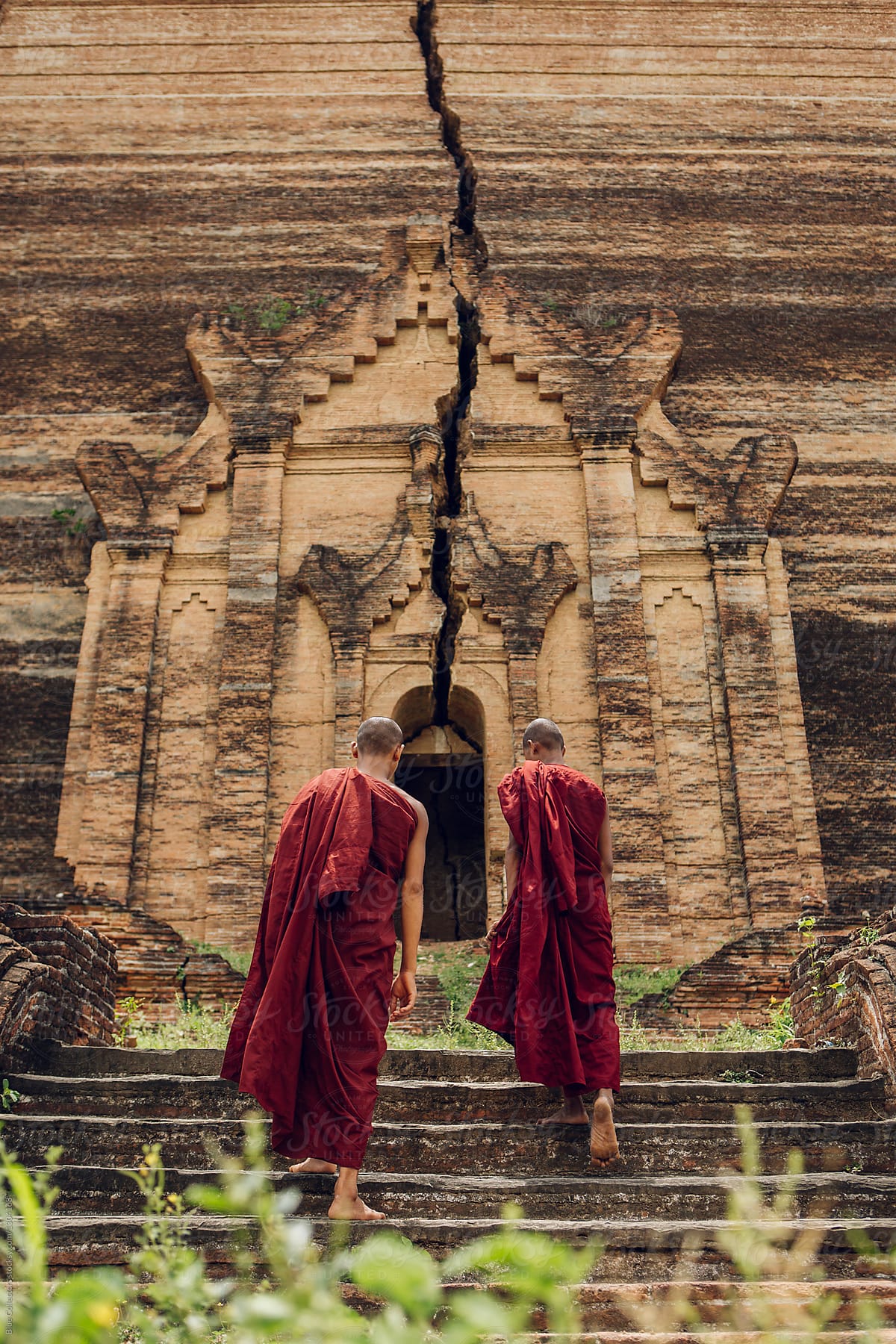 Two novice Buddhist monks walking to a old temple