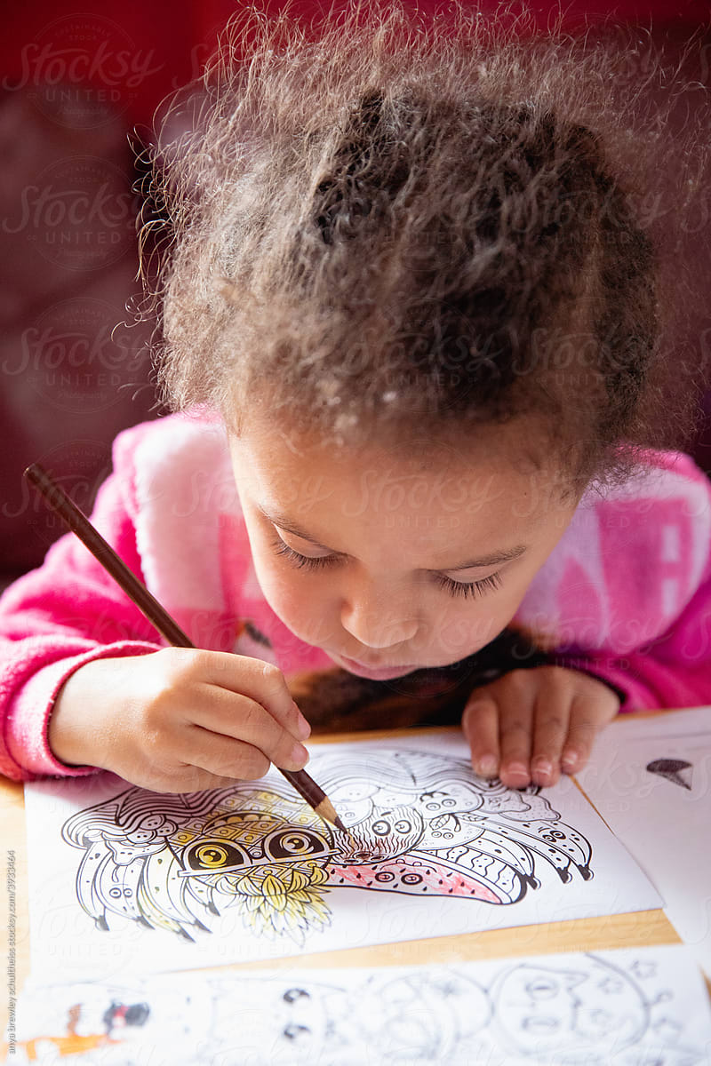 Toddler girl practicing her colouring