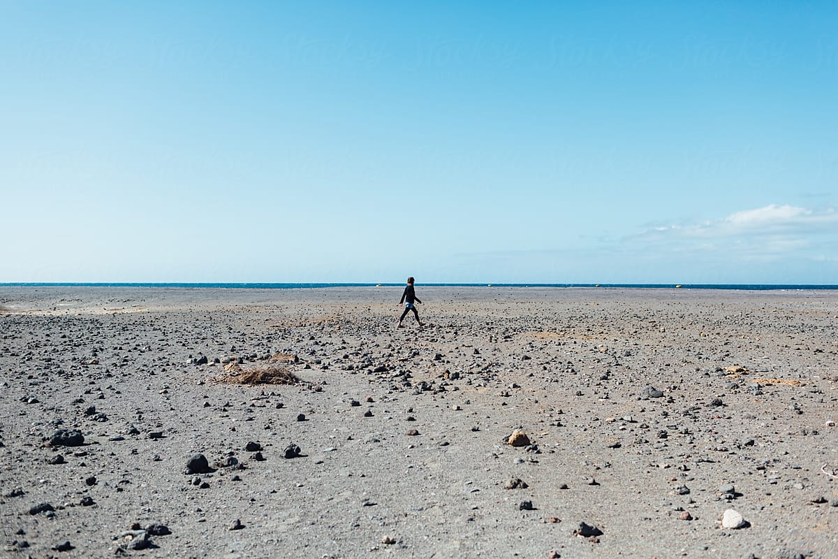 Woman walking on a deserted beach